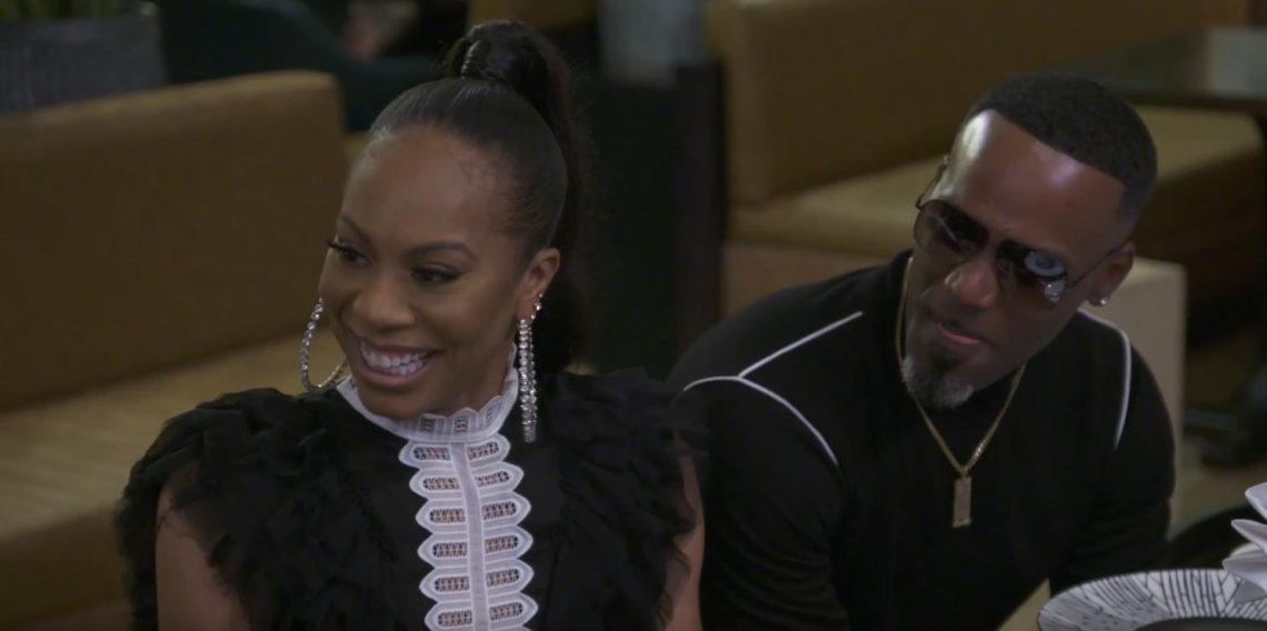 Sanya Richards Ross and her husband sat at dinner table turned to left smiling, Sanyra wears a black and white top with hoop silver earrings, Aaron...
