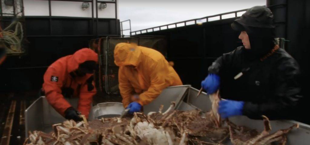 Deadliest Catch crew working on boat measuring crab