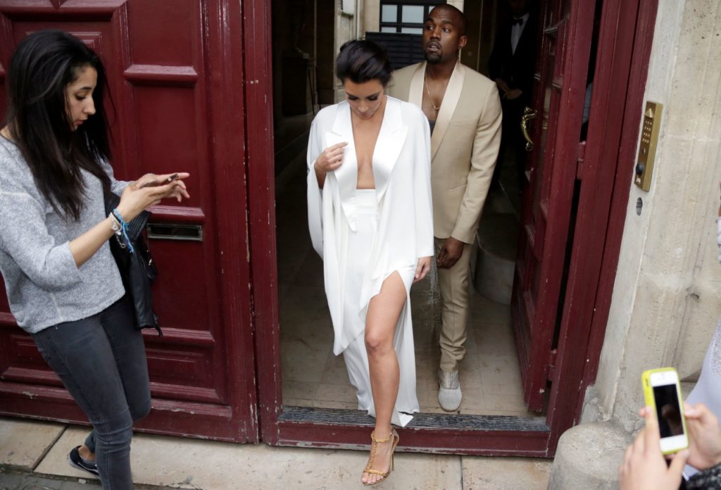 TOPSHOT - American reality TV star Kim Kardashian (L) and American singer Kanye West (R) leave their residence in Paris on May 23, 2014, ahead of t...