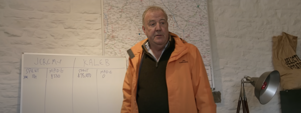 Jeremy Clarkson stands in front of white board