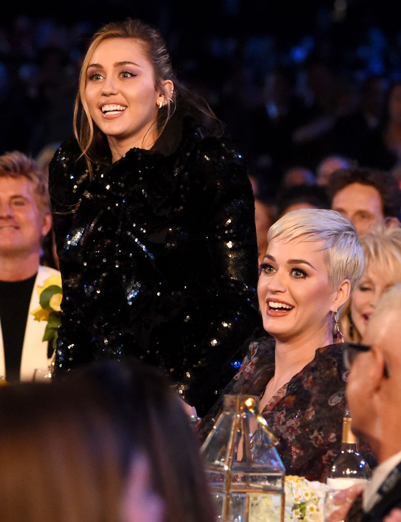 Miley Cyrus (L) and Katy Perry attend MusiCares Person of the Year honoring Dolly Parton at Los Angeles Convention Center on February 8, 2019 in Lo...