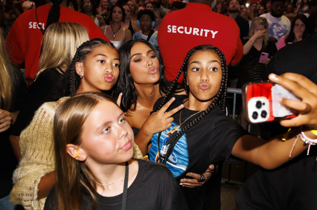 Kim Kardashian, daughter North West, and friends pose for a photo during SZA's performance at the Summerfest Music Festival 2024 on June 22, 2024, ...