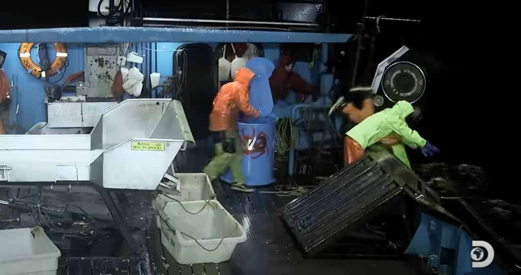 The deck of a boat on Deadliest Catch, one crew member Spencer is seen falling overboard.