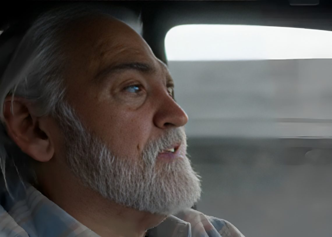 Side profile shot of Deadliest Catch star Wild Bill as he drives car