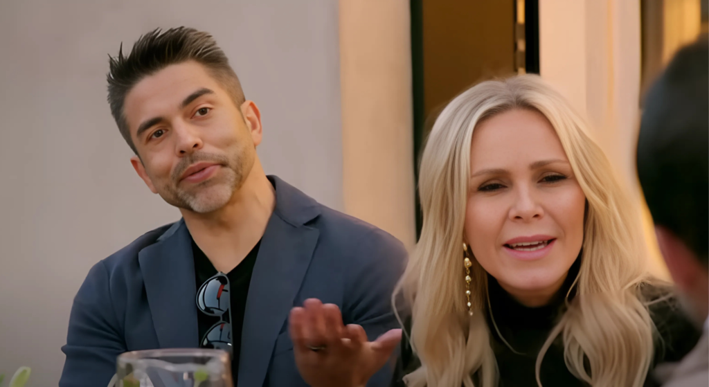 Eddie and Tamra Judge on RHOC sitting at table during row