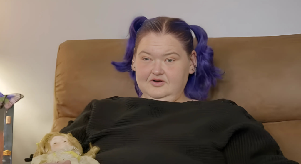 Amy Slaton looks across camera holding doll on 1000-Lb Sisters