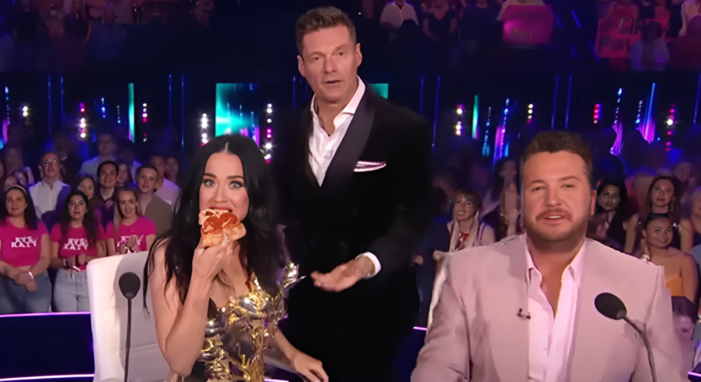 Katy Perry eats pizza sitting next to Luke Bryan and Ryan Seacrest on American Idol