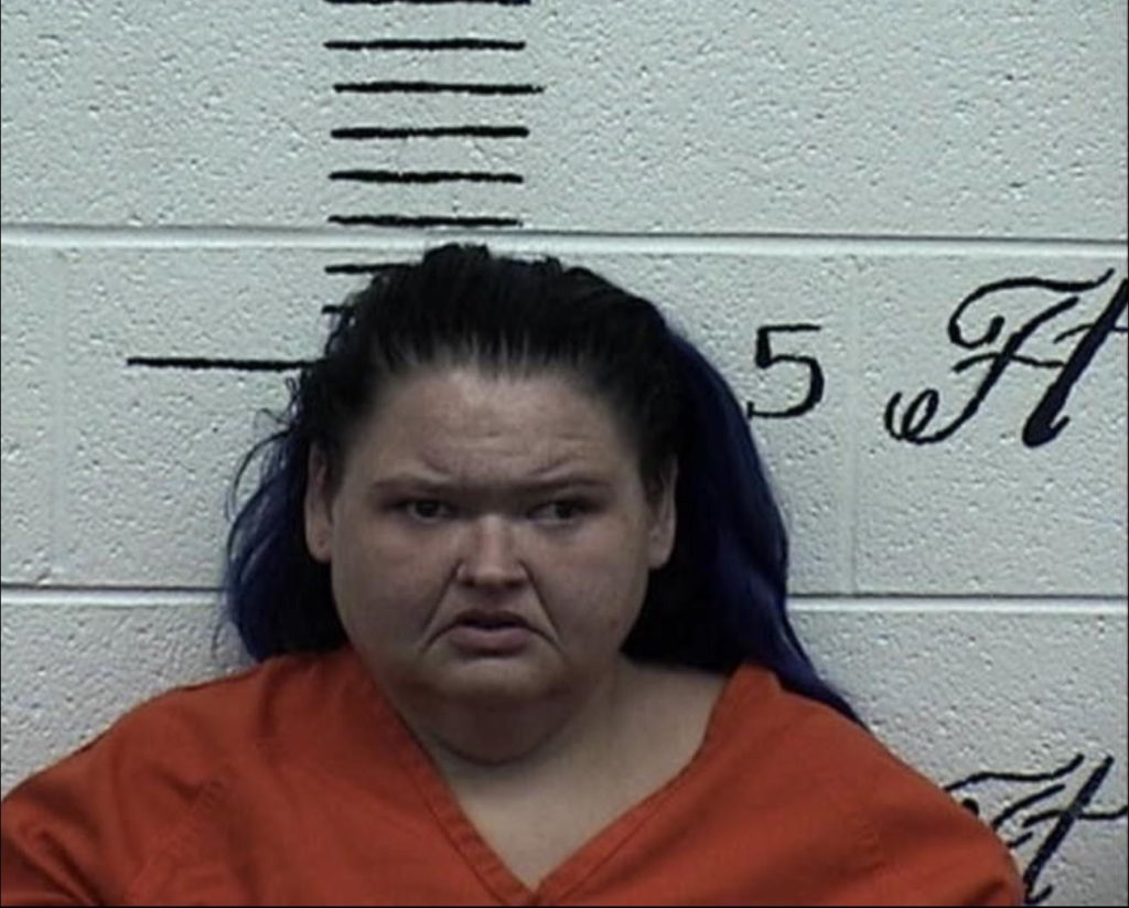 Amy Slaton wears orange top in mugshot.