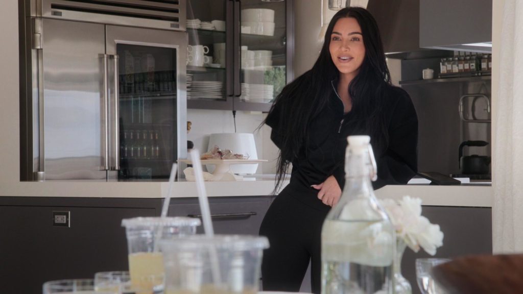 Kim Kardashian smiles filming The Kardashians in kitchen