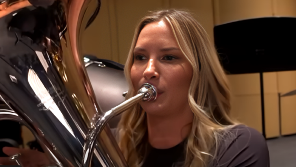 Molly O'Connell blows into trumpet on Southern Charm.