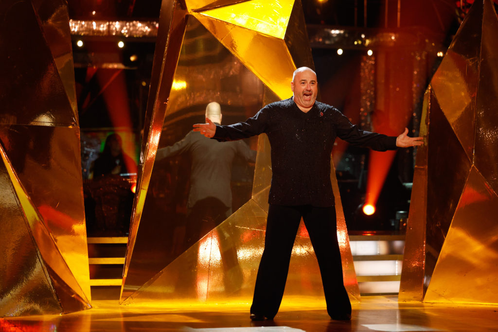 Wynne Evans sings with arms held out to sides on Strictly Come Dancing series 22 Week 8