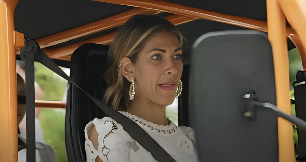 RHONY star Erin Lichy looks across out of shot sitting in buggy during filming