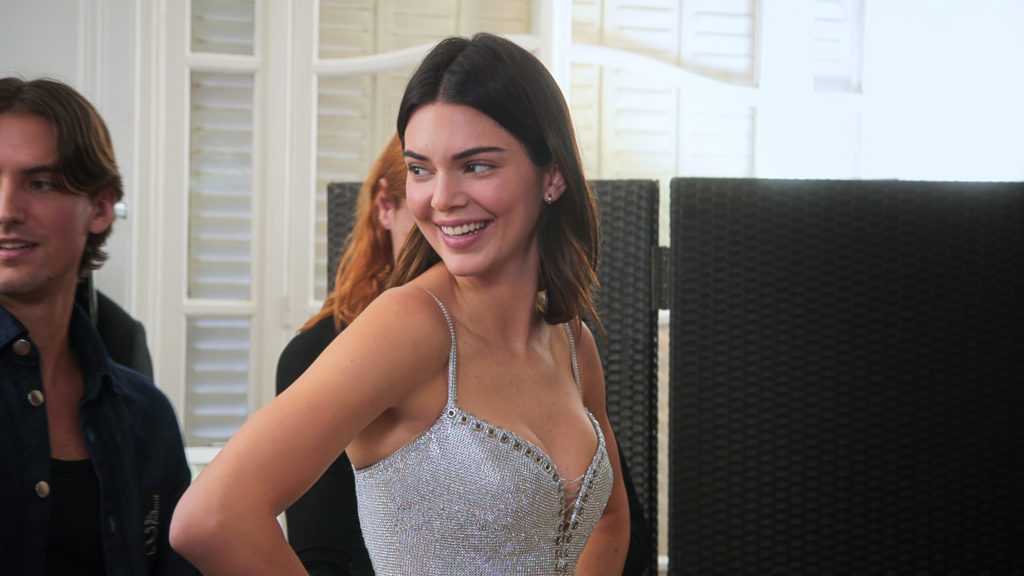 Kendall Jenner smiles looking across to side