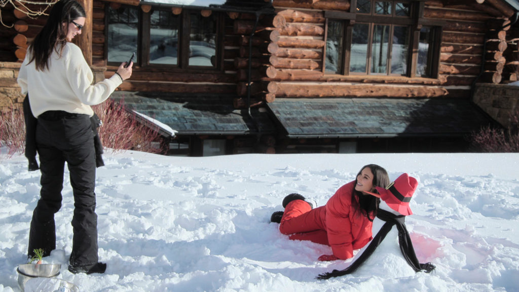 Kendall Jenner takes photo of Kim Kardashian during holiday to Aspen as Kim poses next to snowman