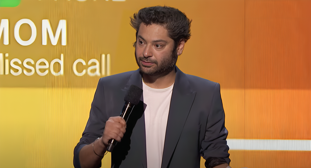 Kabir Singh holds microphone on AGT 2021