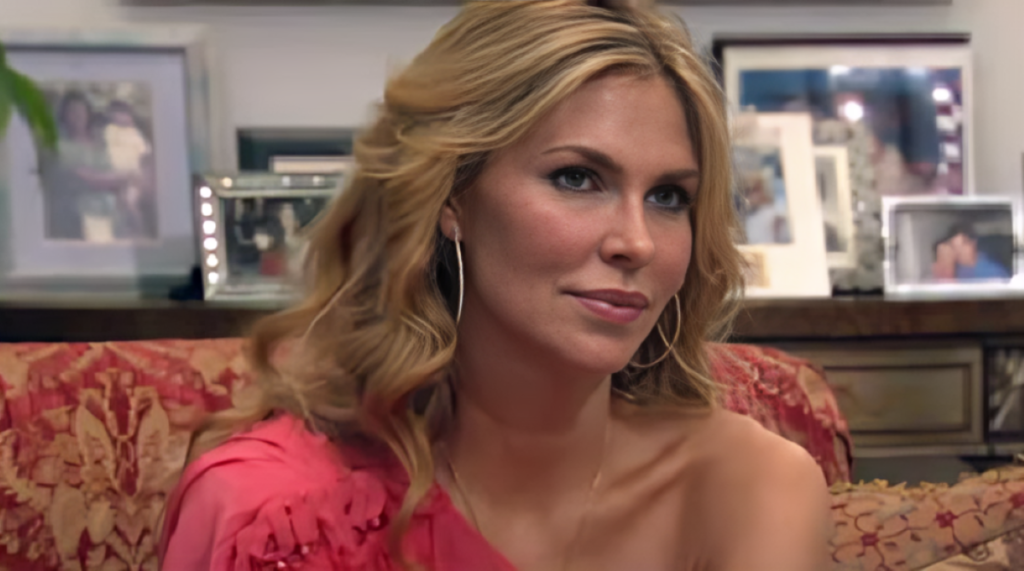 Brandi Glanville wears one-shoulder top and hoop earrings on RHOBH.