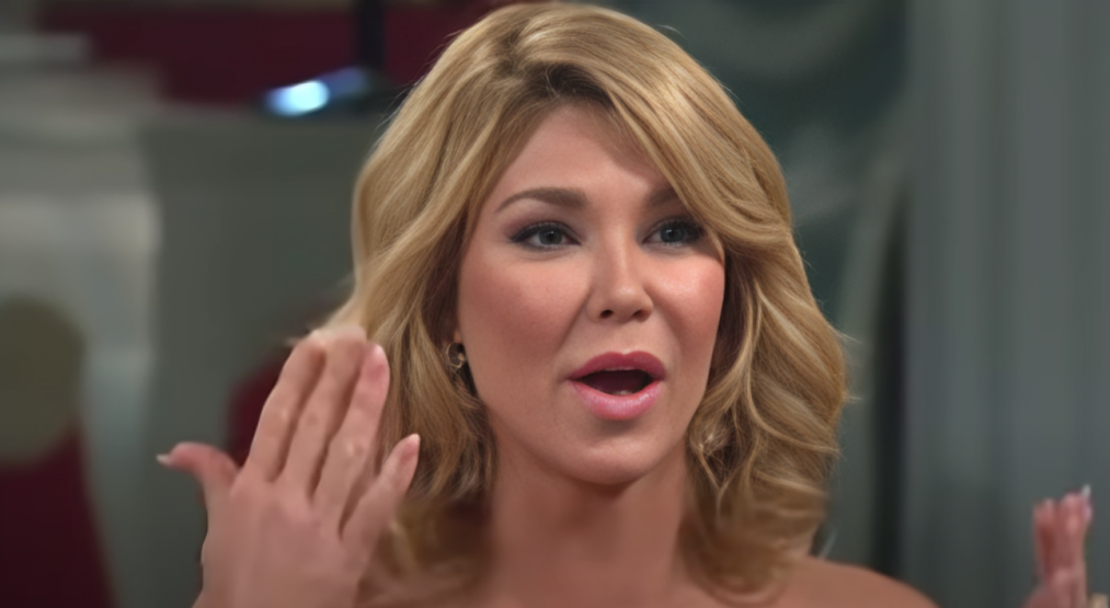 Brandi Glanville holds hands up near face with open mouth on RHOBH.